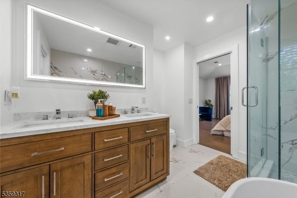Bathroom, Dual Sink Vanities, Glass Shower, Interior, Marble, Marble Walls, Recessed Lighting