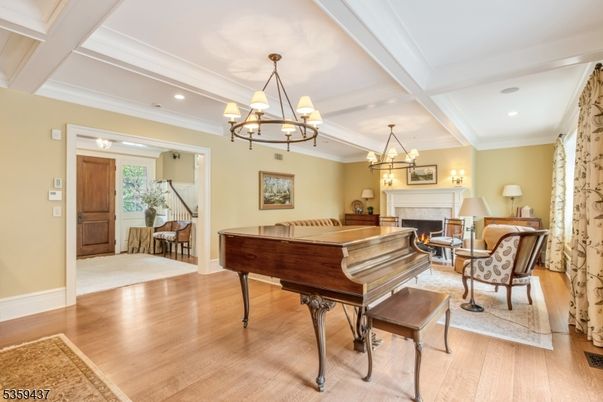 Chandelier, Fireplace, Interior, Living room, Piano, Recessed Lighting, Wood Texture Flooring