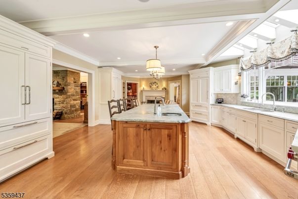 Chandelier, Fireplace, Interior, Kitchen, Recessed Lighting, Stone Walls, Wood Texture Flooring
