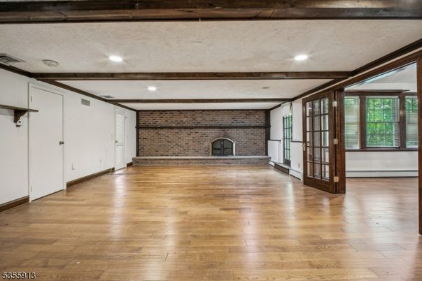 Empty room, Fireplace, Interior, Recessed Lighting, Stone Walls, Wooden Beams, Wood Texture Flooring