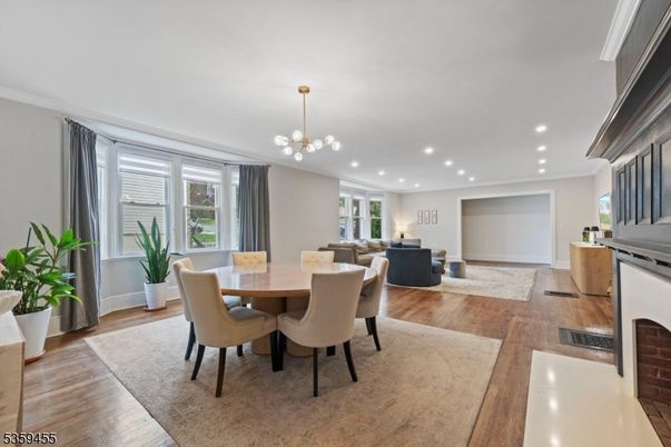 Dining room, Fireplace, Interior, Living room, Pendant Lights, Recessed Lighting, Wood Texture Flooring