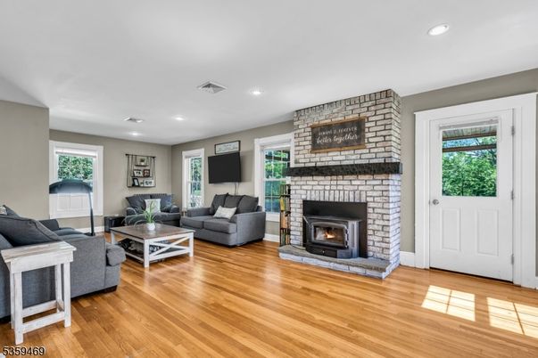 Fireplace, Interior, Living room, Recessed Lighting, Stone Walls, Wood Texture Flooring
