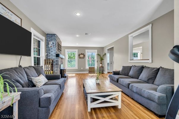 Fireplace, Interior, Living room, Recessed Lighting, Stone Walls, Wood Texture Flooring
