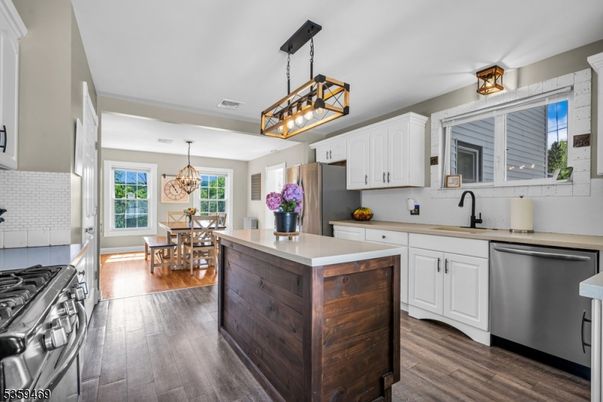Chandelier, Dining room, Interior, Kitchen, Pendant Lights, Stainless Steel Appliances, Wood Texture Flooring