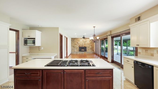 Chandelier, Fireplace, Interior, Kitchen, Pendant Lights, Recessed Lighting, Stainless Steel Appliances, Stone Walls