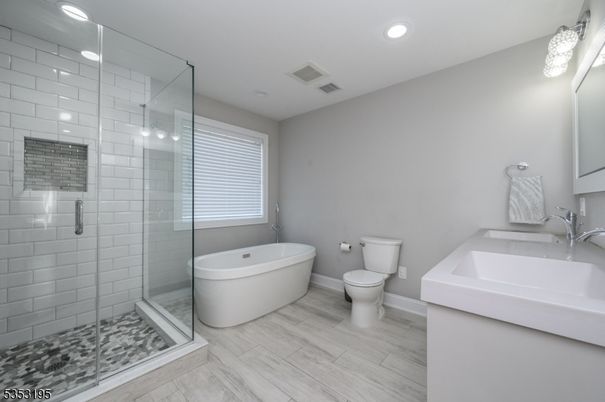Bathroom, Dual Sink Vanities, Free Standing Baths, Glass Shower, Interior, Recessed Lighting, Wood Texture Flooring