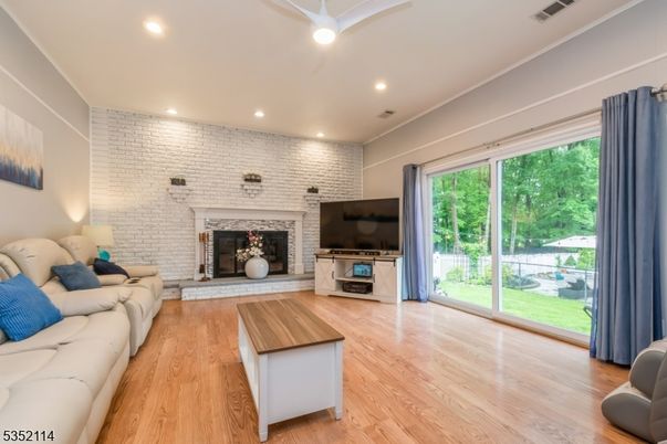 Fireplace, Interior, Living room, Recessed Lighting, Stone Walls, Wood Texture Flooring