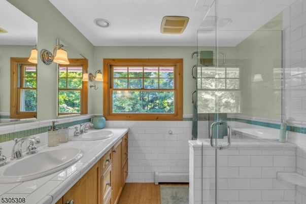 Bathroom, Dual Sink Vanities, Glass Shower, Interior, Recessed Lighting, Tile Countertops, Wood Texture Flooring