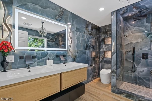 Bathroom, Chandelier, Dual Sink Vanities, Glass Shower, Interior, Marble Walls, Recessed Lighting, Wood Texture Flooring