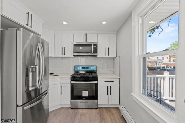 Interior, Kitchen, Marble Walls, Recessed Lighting, Stainless Steel Appliances, Wood Texture Flooring