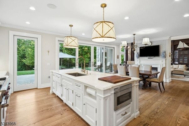 Chandelier, Dining room, Fireplace, Interior, Kitchen, Living room, Pendant Lights, Recessed Lighting, Wood Texture Flooring