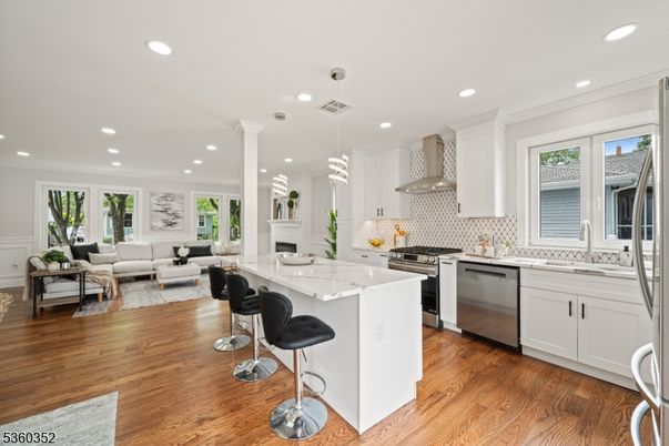 Fireplace, Interior, Kitchen, Living room, Pendant Lights, Recessed Lighting, Stainless Steel Appliances, Wood Texture Flooring