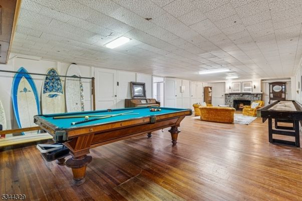 Billiard Table, Fireplace, Game Room, Interior, Living room, Recessed Lighting, Wood Texture Flooring