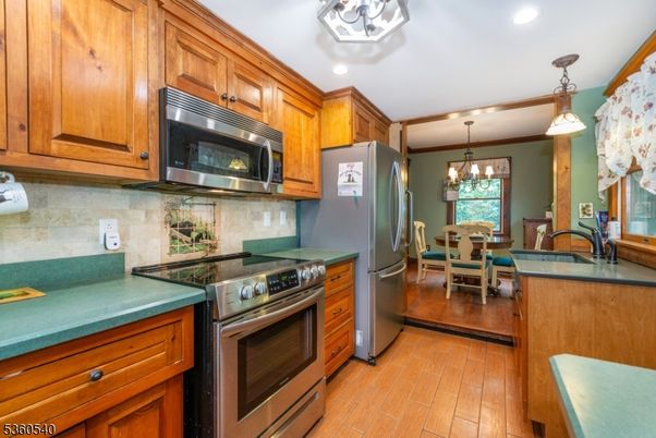 Chandelier, Dining room, Interior, Kitchen, Pendant Lights, Recessed Lighting, Stainless Steel Appliances, Wood Texture Flooring