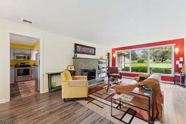 Fireplace, Interior, Living room, Stainless Steel Appliances, Stone Walls, Wood Texture Flooring