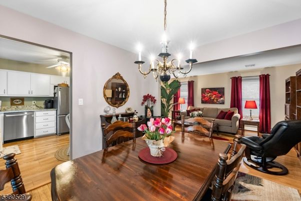 Chandelier, Dining room, Interior, Kitchen, Living room, Stainless Steel Appliances, Wood Texture Flooring