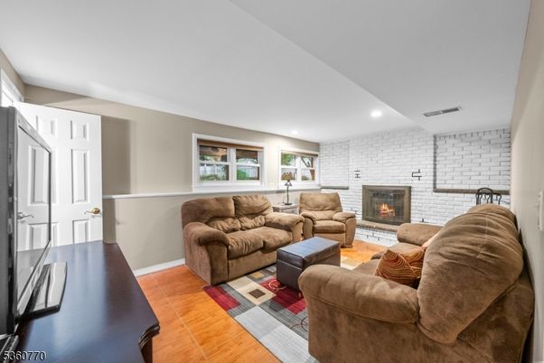 Fireplace, Interior, Living room, Recessed Lighting, Stone Walls, Wood Texture Flooring