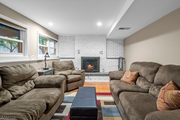 Fireplace, Interior, Living room, Recessed Lighting, Stone Walls, Wood Texture Flooring
