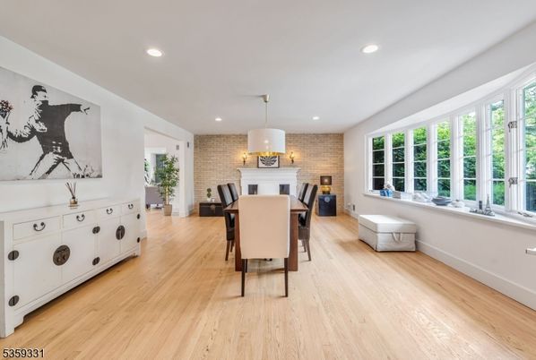 Dining room, Fireplace, Interior, Recessed Lighting, Stone Walls, Wood Texture Flooring