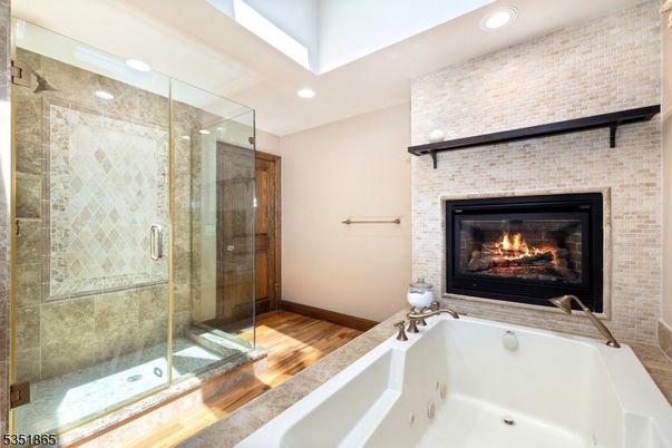 Bathroom, Fireplace, Glass Shower, Interior, Recessed Lighting, Stone Walls, Wood Texture Flooring