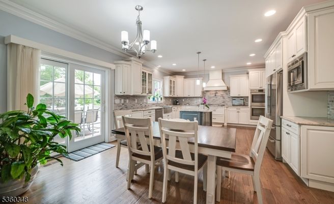 Chandelier, Dining room, Interior, Kitchen, Pendant Lights, Recessed Lighting, Stainless Steel Appliances, Wood Texture Flooring