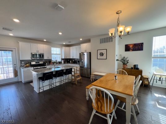 Chandelier, Dining room, Interior, Kitchen, Recessed Lighting, Stainless Steel Appliances, Wood Texture Flooring