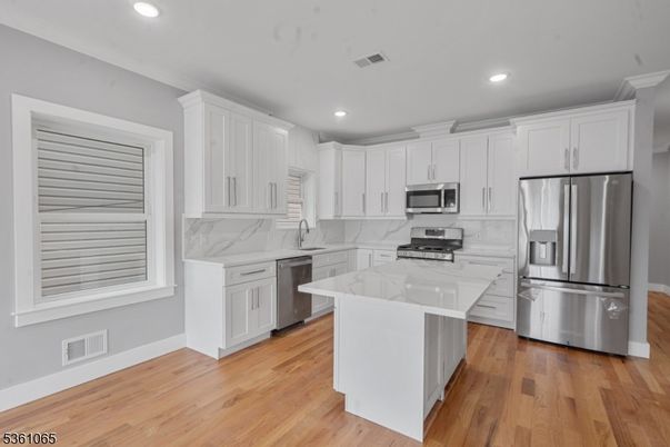 Interior, Kitchen, Marble Walls, Recessed Lighting, Stainless Steel Appliances, Wood Texture Flooring