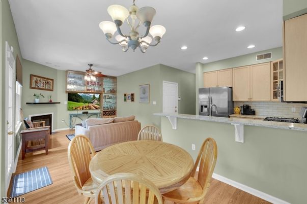 Chandelier, Dining room, Fireplace, Interior, Kitchen, Recessed Lighting, Stainless Steel Appliances, Wood Texture Flooring