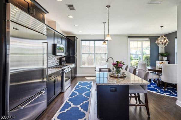 Chandelier, Dining room, Interior, Kitchen, Pendant Lights, Recessed Lighting, Stainless Steel Appliances, Wood Texture Flooring