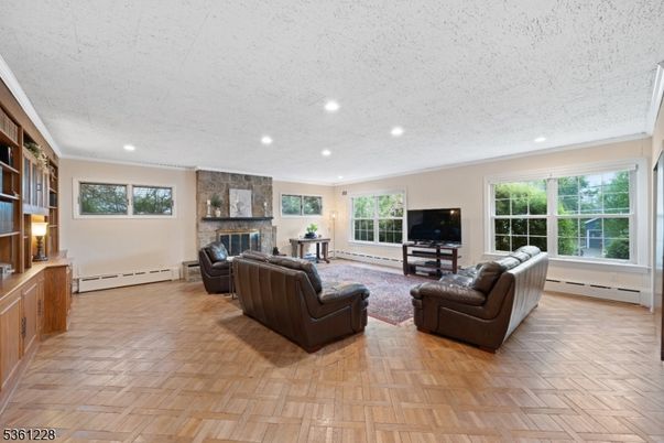 Fireplace, Interior, Living room, Recessed Lighting, Stone Walls, Wood Texture Flooring