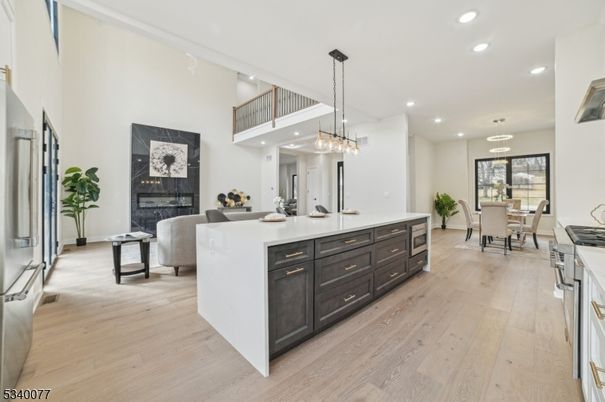 Chandelier, Dining room, Fireplace, Interior, Kitchen, Living room, Pendant Lights, Recessed Lighting, Wood Texture Flooring