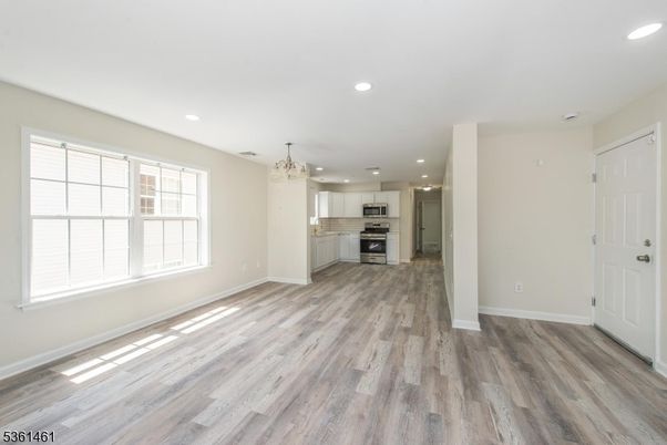 Chandelier, Empty room, Interior, Kitchen, Recessed Lighting, Stainless Steel Appliances, Wood Texture Flooring