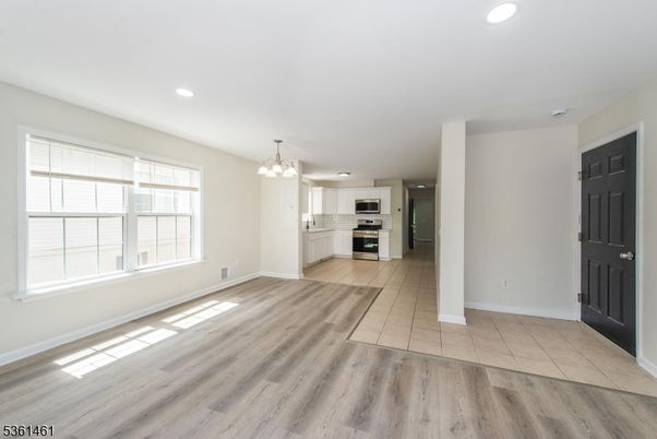 Chandelier, Empty room, Interior, Kitchen, Recessed Lighting, Stainless Steel Appliances, Wood Texture Flooring
