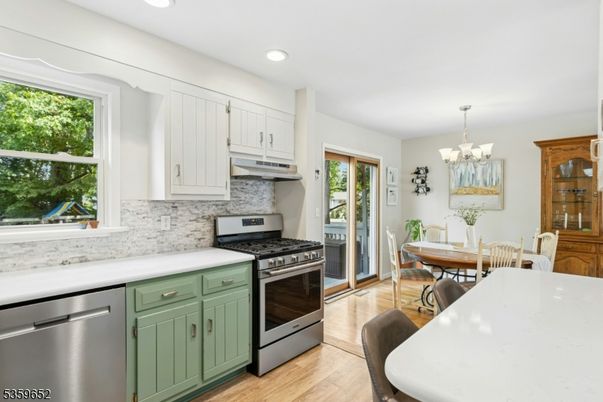 Chandelier, Dining room, Interior, Kitchen, Recessed Lighting, Stainless Steel Appliances, Wood Texture Flooring