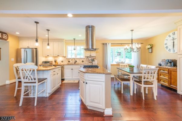 Chandelier, Dining room, Interior, Kitchen, Pendant Lights, Recessed Lighting, Stainless Steel Appliances, Wood Texture Flooring