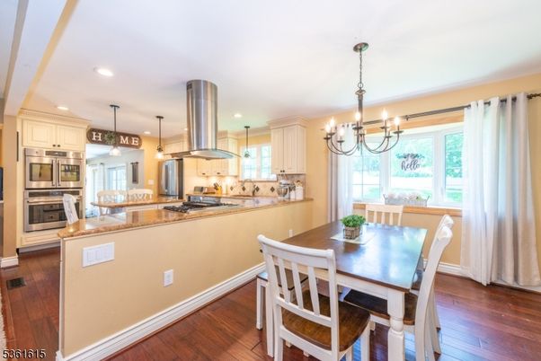Chandelier, Dining room, Interior, Kitchen, Pendant Lights, Recessed Lighting, Stainless Steel Appliances, Wood Texture Flooring