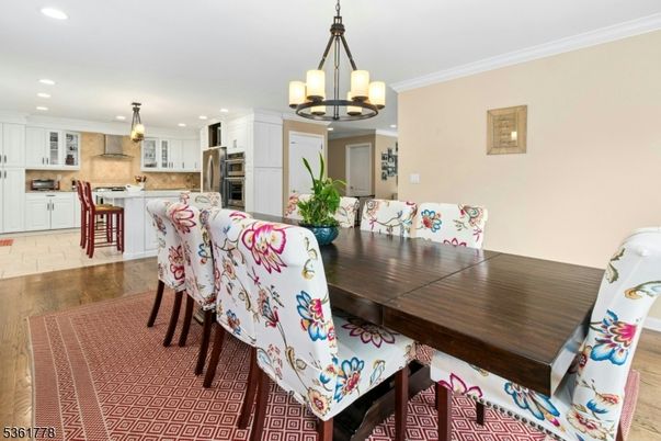 Chandelier, Dining room, Interior, Kitchen, Pendant Lights, Recessed Lighting, Stainless Steel Appliances, Wood Texture Flooring