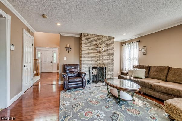 Fireplace, Interior, Living room, Recessed Lighting, Stone Walls, Wood Texture Flooring