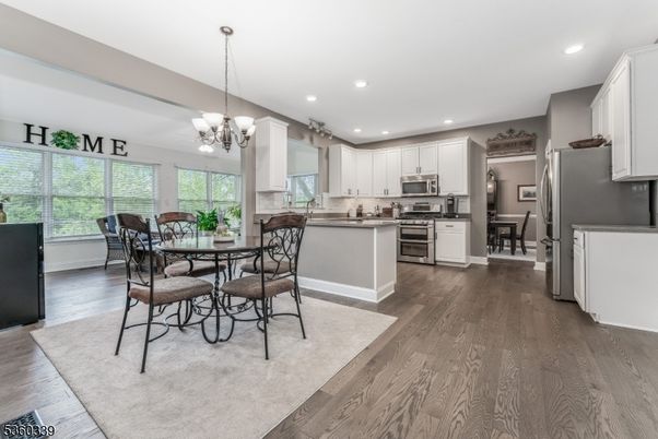 Chandelier, Dining room, Interior, Kitchen, Pendant Lights, Recessed Lighting, Stainless Steel Appliances, Wood Texture Flooring