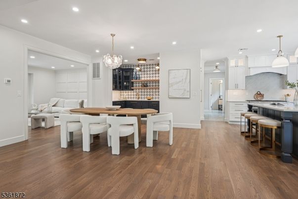 Chandelier, Dining room, Interior, Kitchen, Living room, Pendant Lights, Recessed Lighting, Stainless Steel Appliances, Wood Texture Flooring