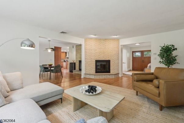 Dining room, Fireplace, Interior, Living room, Recessed Lighting, Stone Walls, Wood Texture Flooring