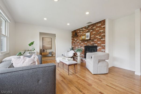 Fireplace, Interior, Living room, Recessed Lighting, Stone Walls, Wood Texture Flooring