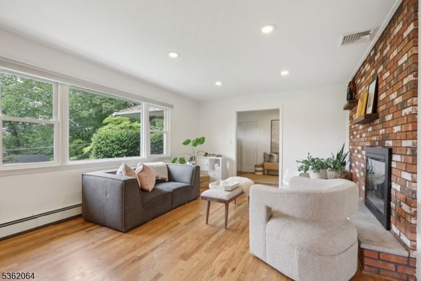 Fireplace, Interior, Living room, Recessed Lighting, Stone Walls, Wood Texture Flooring