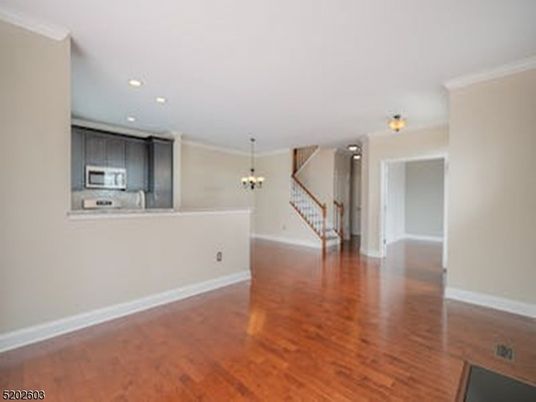 Chandelier, Empty room, Interior, Kitchen, Recessed Lighting, Stainless Steel Appliances, Wood Texture Flooring