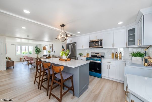Dining room, Interior, Kitchen, Pendant Lights, Recessed Lighting, Stainless Steel Appliances, Wood Texture Flooring