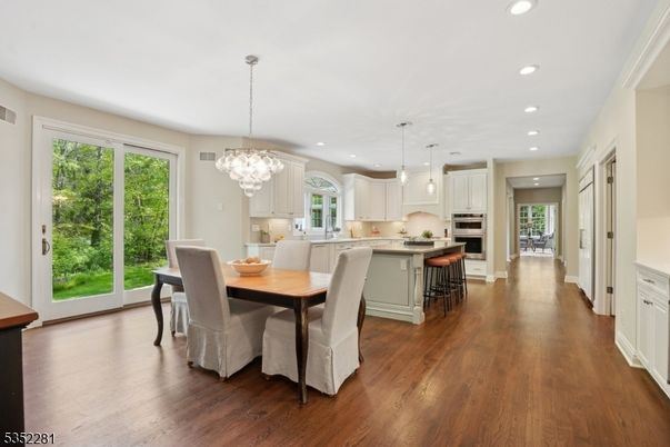 Chandelier, Dining room, Interior, Kitchen, Pendant Lights, Recessed Lighting, Stainless Steel Appliances, Wood Texture Flooring