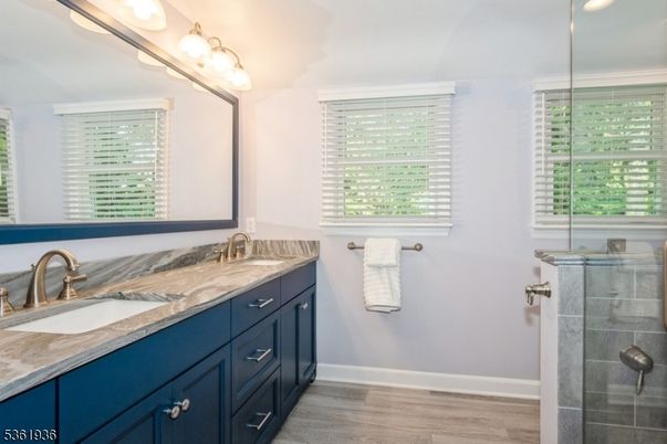 Bathroom, Dual Sink Vanities, Glass Shower, Interior, Recessed Lighting, Wood Texture Flooring