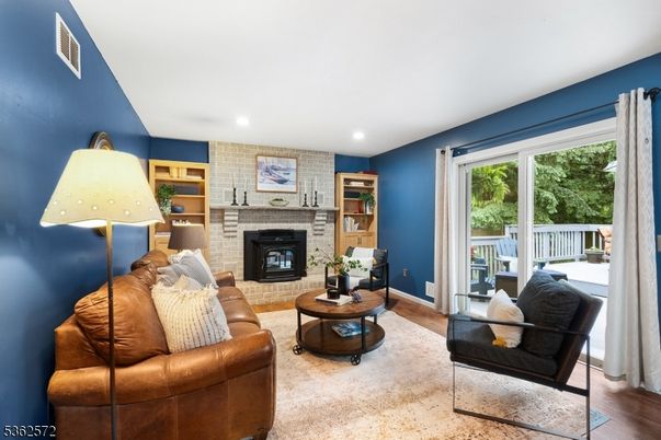 Fireplace, Interior, Living room, Recessed Lighting, Stone Walls, Wood Texture Flooring