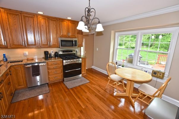 Dining room, Interior, Kitchen, Pendant Lights, Recessed Lighting, Stainless Steel Appliances, Wood Texture Flooring