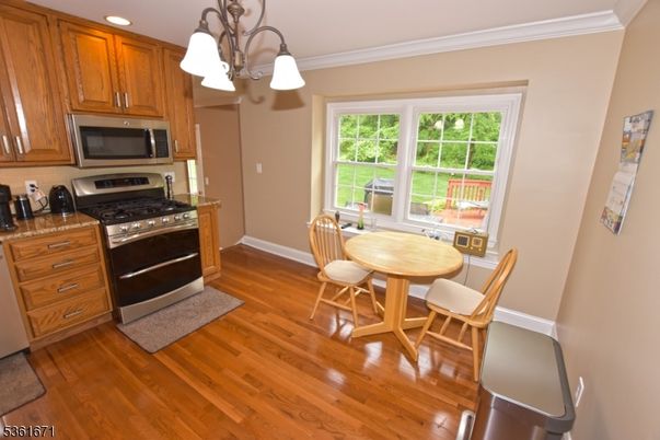 Dining room, Interior, Kitchen, Recessed Lighting, Stainless Steel Appliances, Wood Texture Flooring